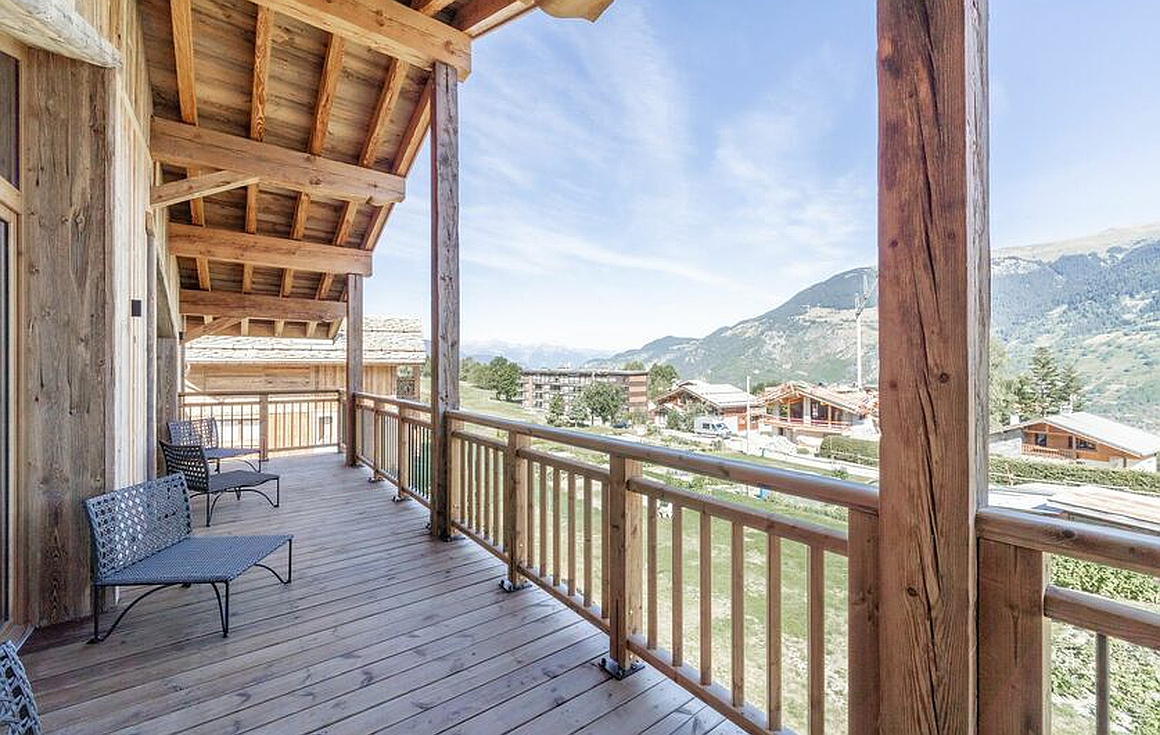 Expansive wooden terrace with alpine scenery