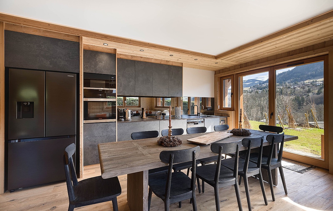Modern kitchen-dining space with scenic views