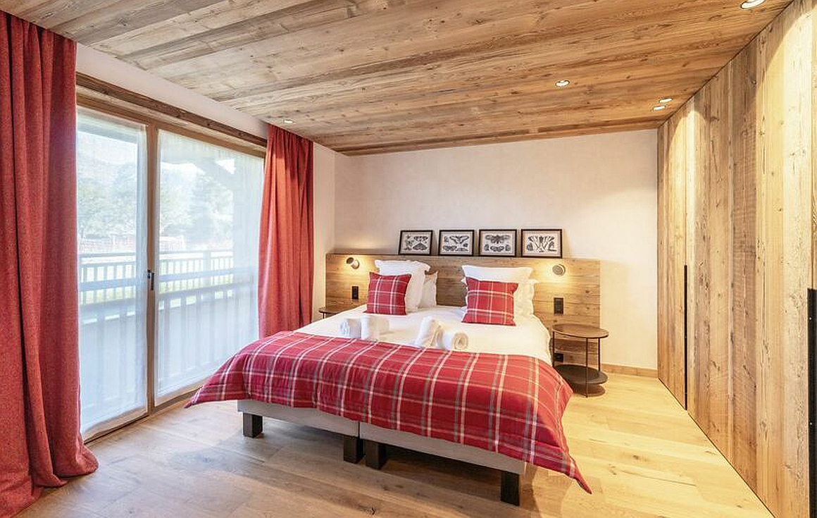 Stylish bedroom with red and wood tones